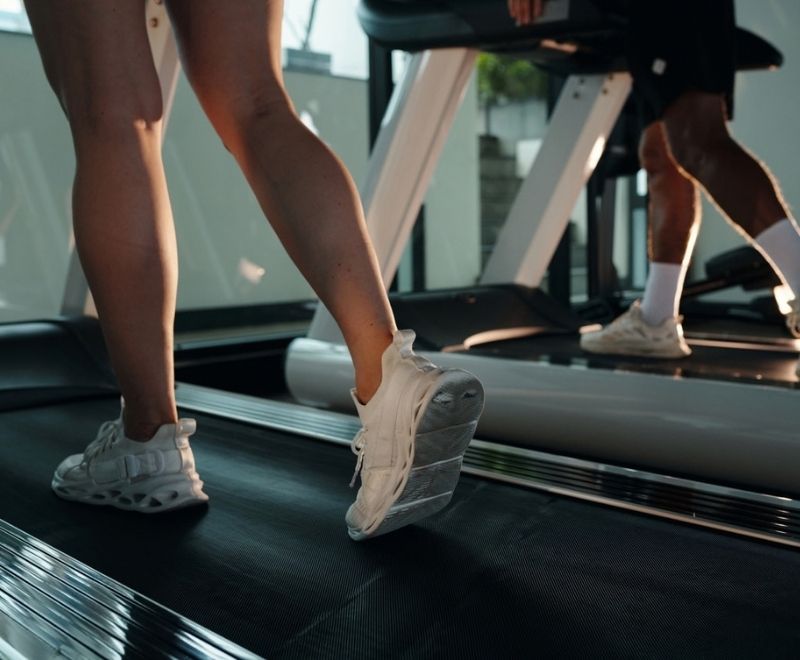 Lower legs walking on a treadmill as an example of exercise that supports vein health and circulation.